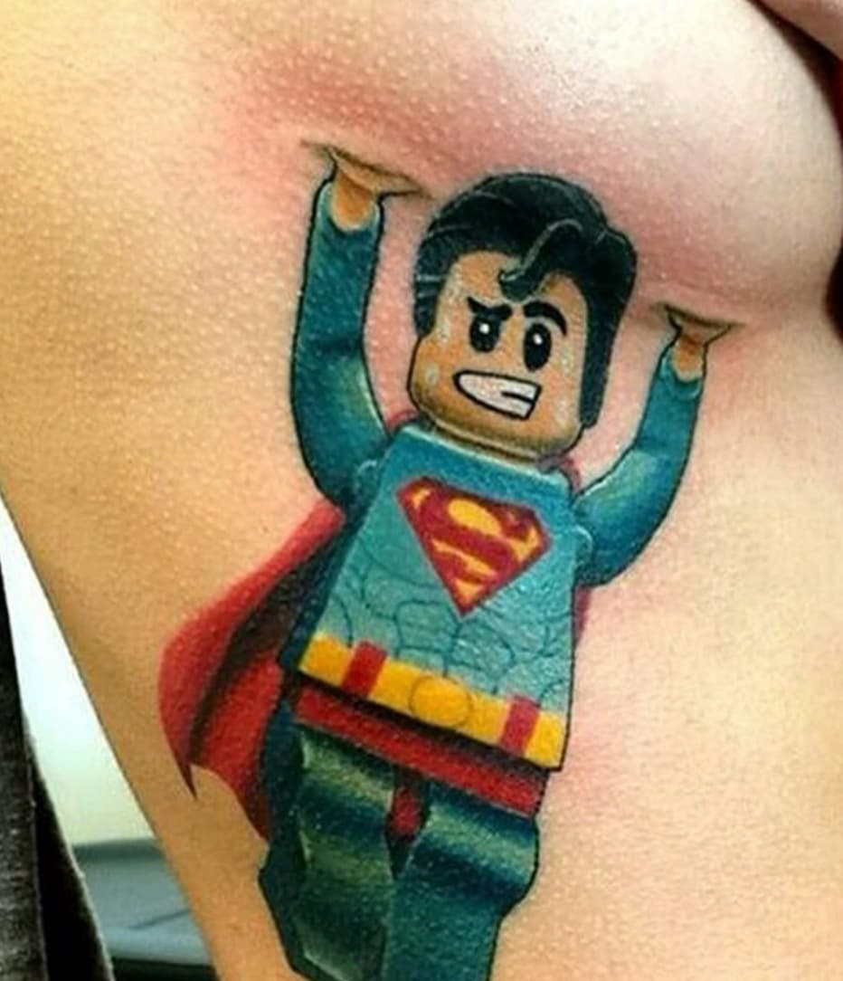 superman holding up boob tattoo